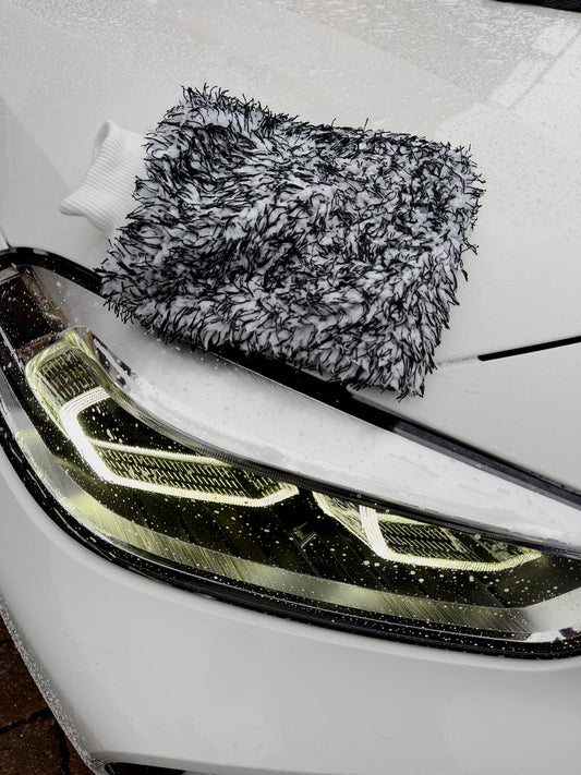 Microfibre wash mitt on car front headlight by Driven Digits
