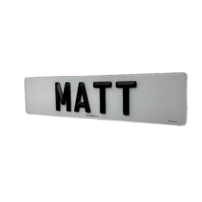 A number plate with Matte 4D retro letters spelling 'MATT', mounted on a plain white wall.