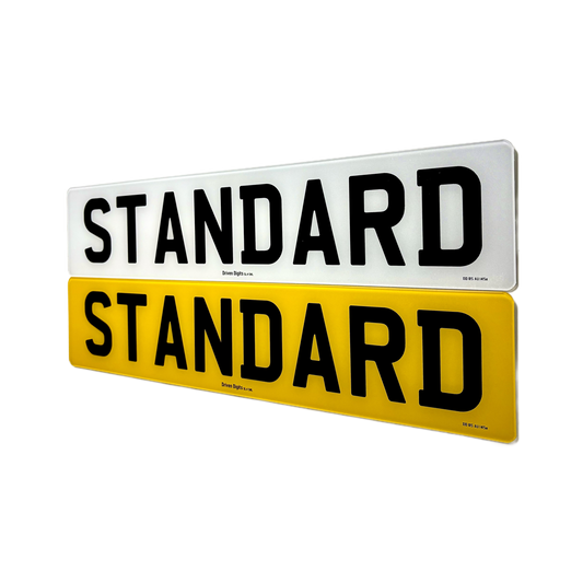 Two rectangular sign plates shown on a white background, one white with black text reading STANDARD and one yellow with black text reading STANDARD.