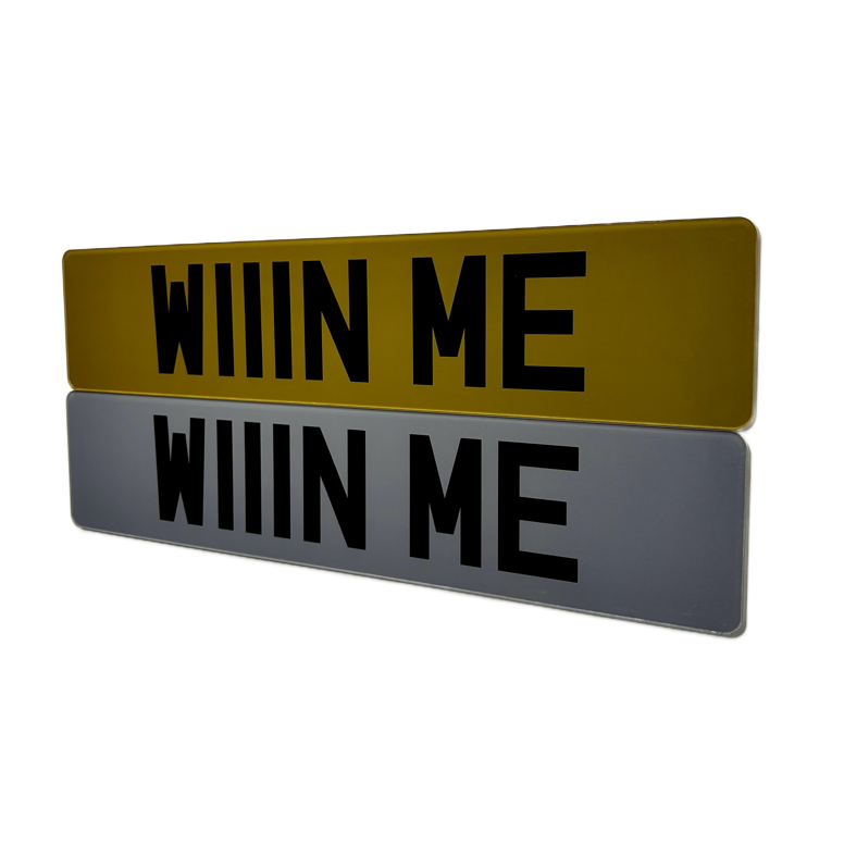 A pair or tinted printed show number plates saying win me for a car competition company TWD Comps