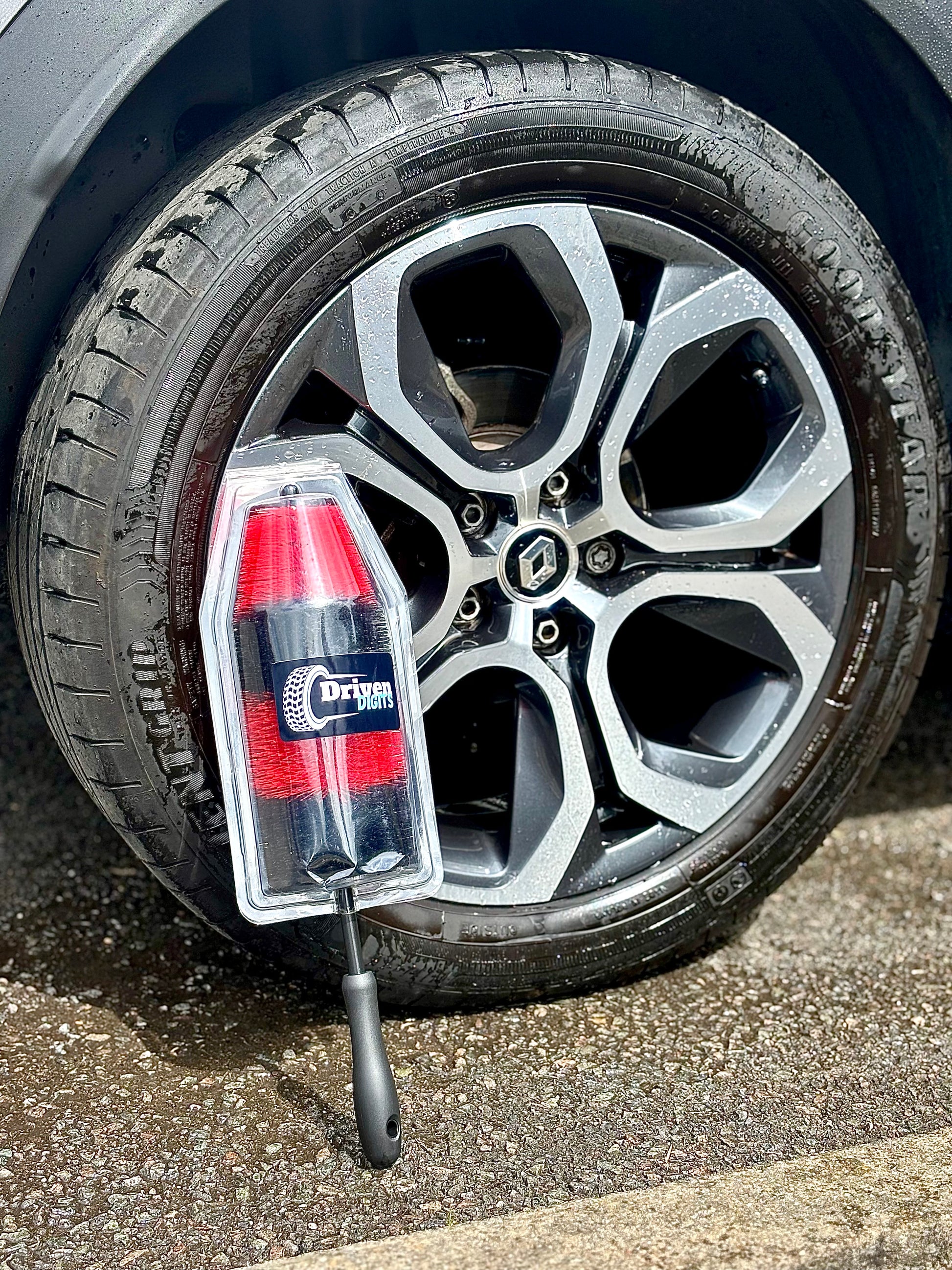 Car wheel showing a wheel cleaning brush by Driven Digits